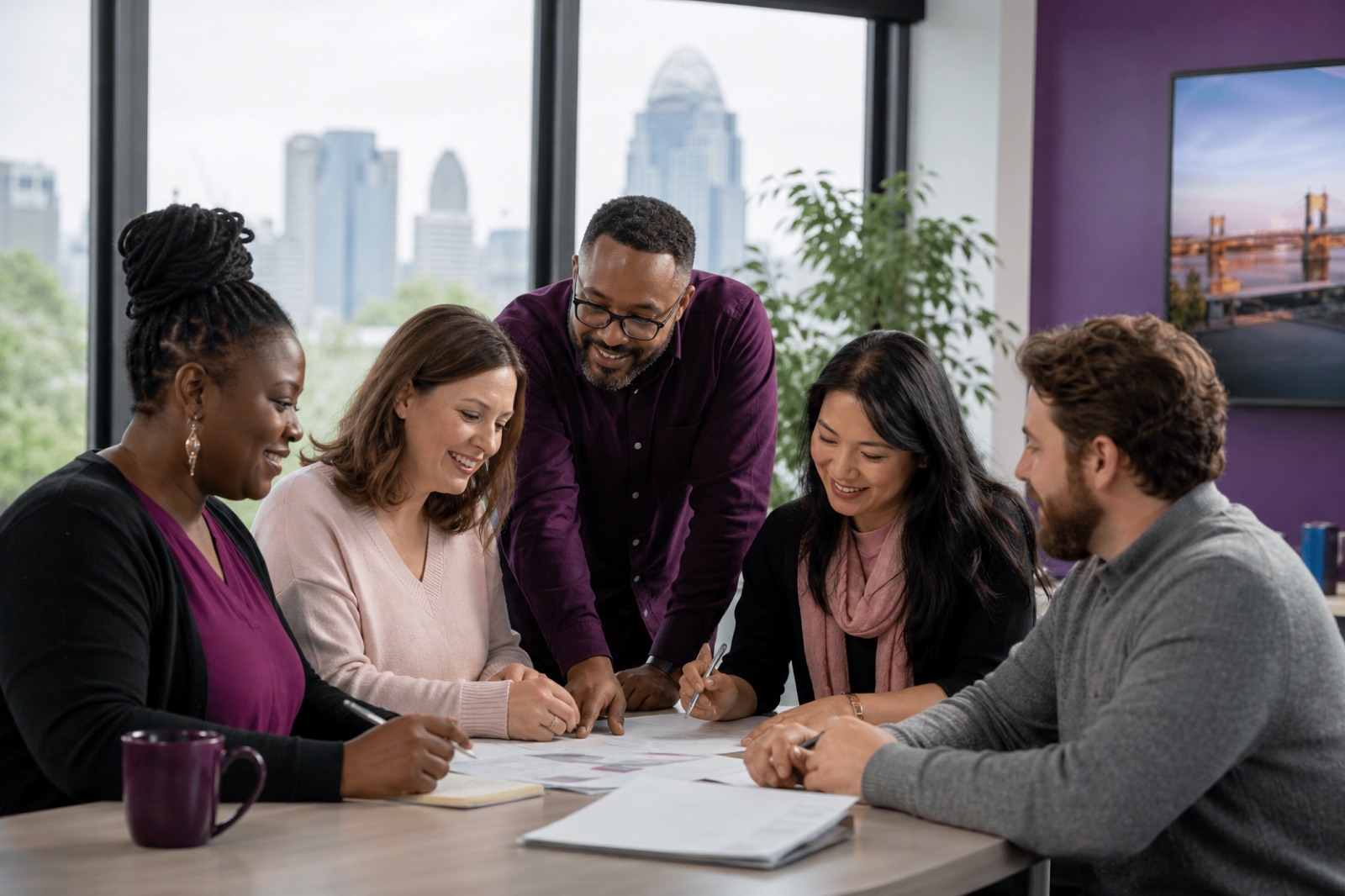 A diverse Cincinnati community support team collaborating in a bright office